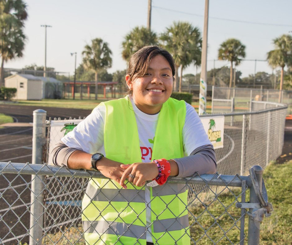 An Immokalee Foundation student volunteers at a Foundation-sponsored event.
